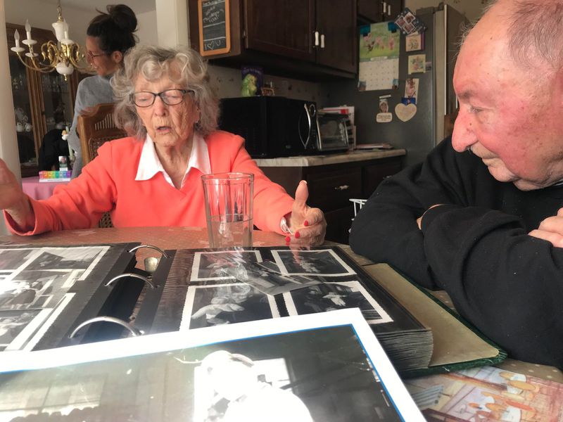 Jackie Smith, 95, and Marty Smith, 94, look through old photos of their life together in Europe before immigrating to Canada, then the U.S. after marrying in France. (Jackie Smith)