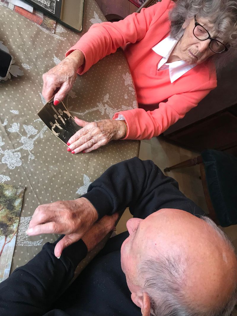 Jackie and Marty Smith look through old photos in their kitchen of their Lakes of the Four Seasons home on March 2. (Jerry Davich)