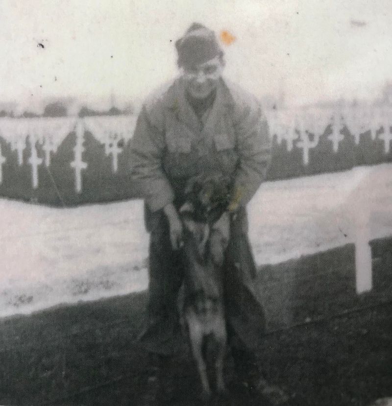 Martin Schmidt worked for the U.S. military in many capacities in France. This included raising American flags each day over three cemeteries filled with thousands of soldiers killed in the war. His only companion was a wandering mutt like him, Max. “He followed me everywhere,” he said. (Marty Smith)